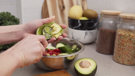 Putting-avocado-into-salad