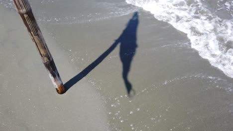 Silhouette-of-a-waving-flag-in-beach-shore