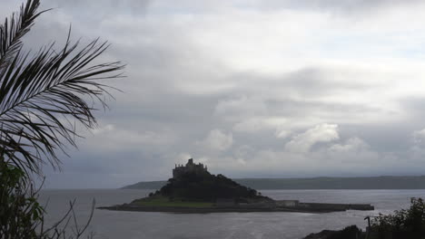 View-from-a-terrace-in-Marazion-of-the-english-medieval-castle-and-church-of-St-Michael's-Mount-in-Cornwall-on-a-cloudy-spring-day