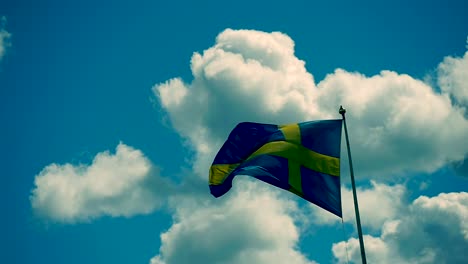 The-Swedish-flag-waves-intensely-on-a-windy-summer-day
