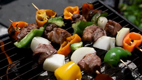 meat-and-vegetable-kabobs-over-hot-charcoal-briquettes-being-grilled-outdoors