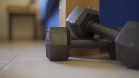 Person-gets-out-of-bed-but-doesn't-want-to-pick-up-workout-weights