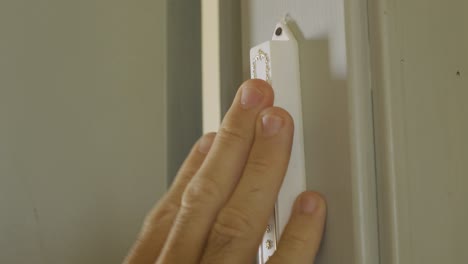 Extreme-Close-Up---Hand-touches-a-Jewish-Door-keeper---mezuzah