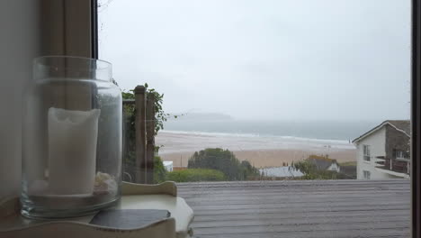 Raindrops-Falling-against-Glass-Doors-in-Slow-Motion-with-an-Ocean-View