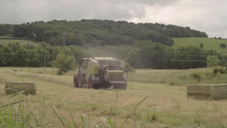 Tractor-in-hay-fields-pulling-a-baler