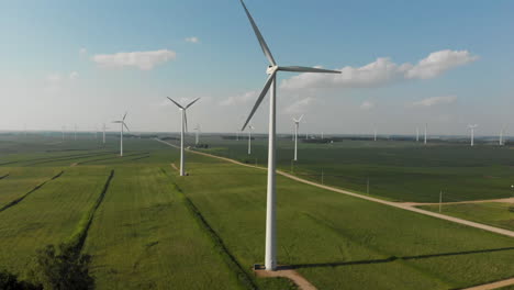 Aerial-video-of-flying-up-and-around-a-wind-generator-in-a-cornfield-on-a-sunny-day-in-Iowa