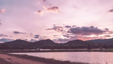 Time-lapse-sunset-sky-over-lake-and-mountain-in-warm-sweet-tone