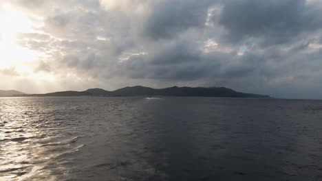 Time-Lapse-of-a-boat-travelling-across-the-ocean-on-a-cloudy-day-with-grey-sky