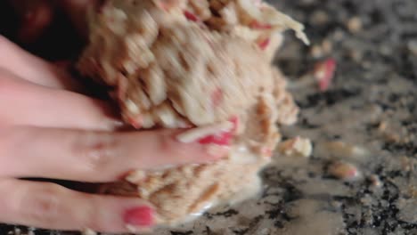 Close-up-of-woman-hands-joining-together-grated-apples-with-whole-wheat-dough