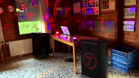 Dj-desk-on-a-60th-birthday-with-laptop,-music-boxes-speakers-and-light-effects