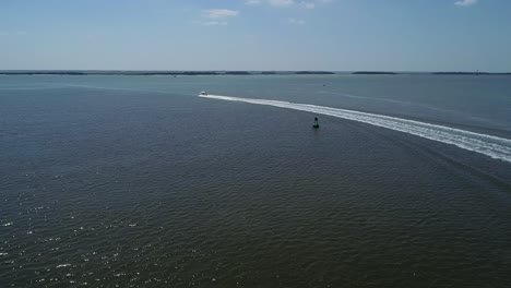 Following-a-boat-at-Fernandina-beach-flying-near-Amelia-Island-on-a-peaceful-sunny-summer-day-chasing-a-boat