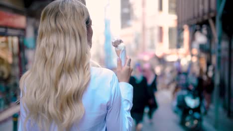 Slow-Motion:Young-beautiful-girl-eats-ice-cream-while-walking-at-narrow-street-in-Europe