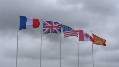 Flags-of-different-nations-fluttering-against-cloudy-sky