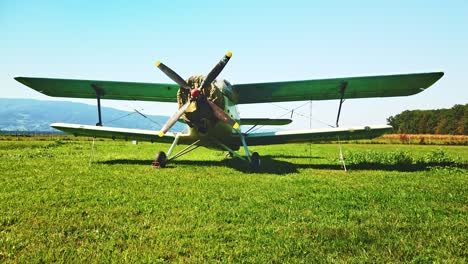 Russian-Antonov-An-2-on-grass-airfield,-vintage-Soviet-propeller-airplane