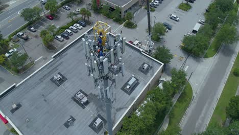 4k-Luftvideo-Von-Technikern,-Die-Auf-Einen-Mobilfunkturm-Klettern