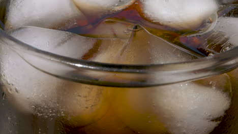Slow-motion-macro-close-up,-refreshing-glass-of-ice-and-cola