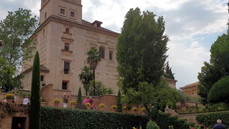 Tourists-visiting-gardens-of-Santa-Maria-church,-Alhambra