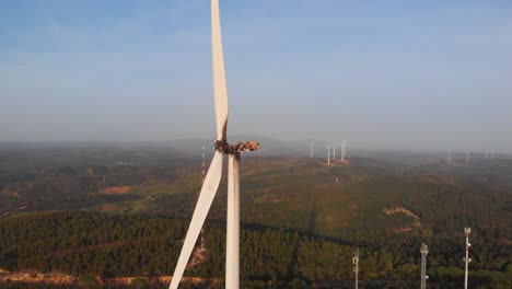 Aerial-close-up-of-burnt-out-wind-turbine-with-wind-farm-in-background