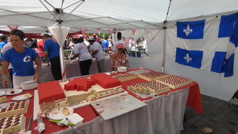 Public-banquet,-canada-day,-hostess-serving-cake-to-people,-happy-birthday-party,-gourmet-event,-festival,-national-canada-day-ceremony,-Quebec-flag