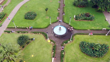 AERIAL-Approach-To-Directly-Over-A-Water-Fountain-In-A-Town-Park