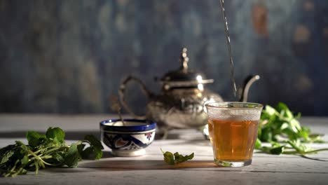 Cinemagraph-of-tea-pouring-into-a-glass-with-Moroccan-tea-set-and-mint