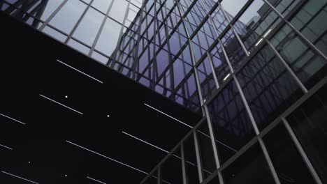 Glass-wall-of-modern-building,-art-low-angle-shot