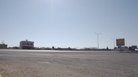 A-tourist-bus-passes-on-the-desert-road-in-Jordan