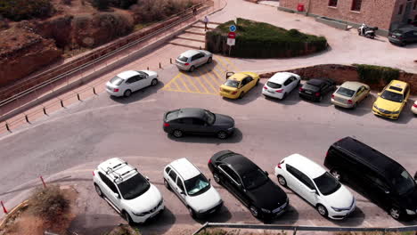 BMW-car-driving-around-sharp-corner-in-Greece,-aerial-panning-shot