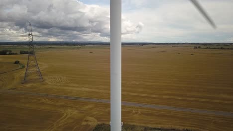 Aerial-pedestal-shot-of-wind-turbine-in-operation