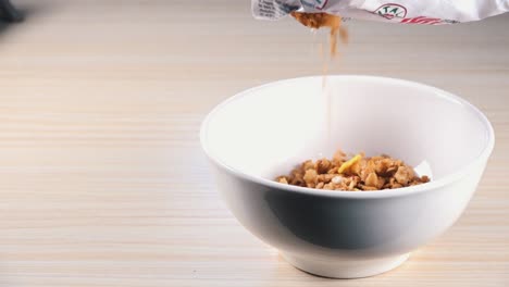 Slow-Motion-Shot-of-Cereal-Being-Poured-into-a-Breakfast-Bowl