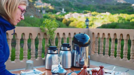 Blonde-tourist-girl-having-typical-moroccan-breakfast-in-High-Atlas-mountains