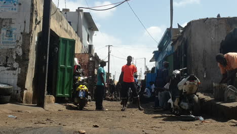 men-at-work-on-busy-day-at-street-of-dakar,-still-shot-low-angle