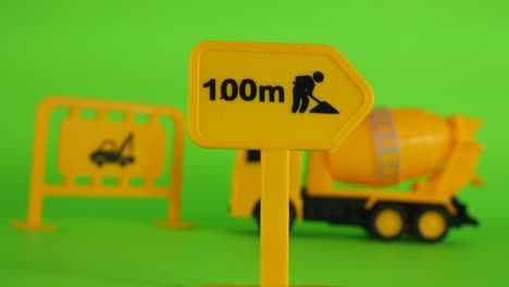Green-screen-illustration,-construction-site,-truck-and-equipment,-toy-miniature-model,-background-cinematic-concept-of-creative-mini-figurine-of-workplace
