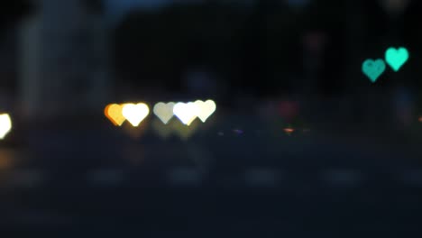 Beautiful-hearts-bokeh-from-moving-car-and-traffic-lights-at-the-evening,-Valentines-Day,-wedding-day-or-social-media-Like-background-concept