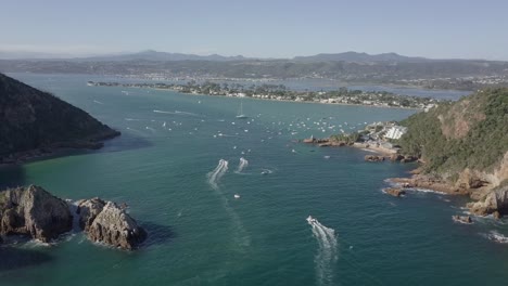 Aerial:-Busy-waterway-of-Knysna-Heads-and-Lagoon-on-a-sunny-day
