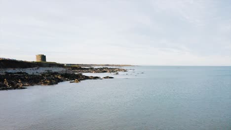 The-beautiful-rocky-shore-in-Balbriggan-with-a-few-of-people-walking-around