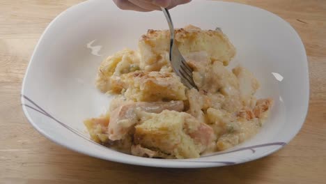 Medium-Slow-Motion-Shot-of-Eating-Fish-Pie-from-a-Bowl