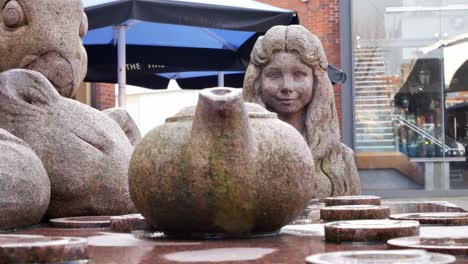 Mad-hatter-tea-party-teapot-Alice-parallax-granite-carved-sculpture-in-Warrington-town-Golden-square