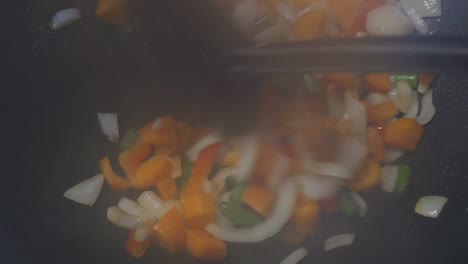 Close-up-of-cooking-fresh-vegetables-in-wok,-steamy-stir-fry,-colorful
