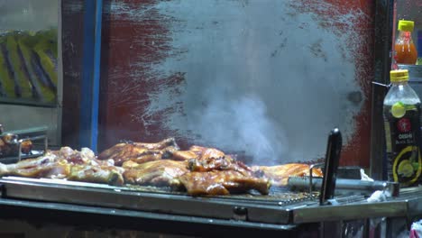 Close-Exterior-Shot-of-Chicken-Smoking-on-Grill