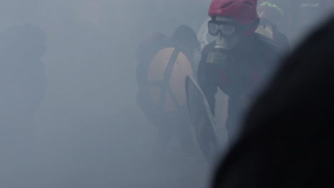 Clouds-of-tear-gas-force-protestors-to-retreat-during-a-protest-in-Santiago,-Chile