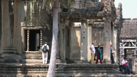 Medium-Exterior-Shot-of-Tourist-Standing-Outside-of-Entrance-of-Temple