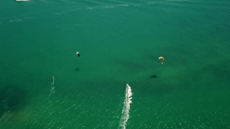 high-altitude-top-down-drone-shot-of-Kite-surfers-in-turquise-Atlantic-ocean