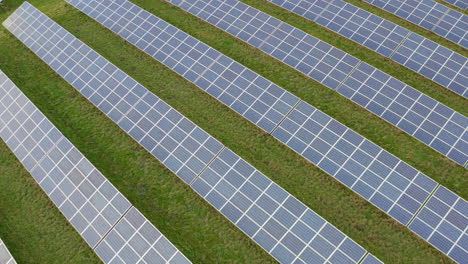 A-solar-farm-in-Staffordshire,-thousands-of-Solar-Panels-capturing-the-sun's-natural-light-and-converting-it-into-renewable,-sustainable-energy-due-to-the-ongoing-climate-change,-natural-energy
