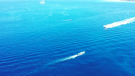 Cruise-ships-sailing-across-the-bright-blue-ocean-during-a-beautiful-sunny-day