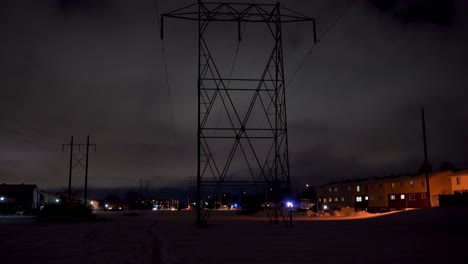 Tall-Hydro-Towers-Running-Through-a-Suburban-Area-at-Night