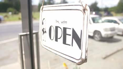 Yes-We're-Open-Signage-Hanging-On-The-Glass-Door-Of-A-Store-In-New-Zealand---Closeup-Shot