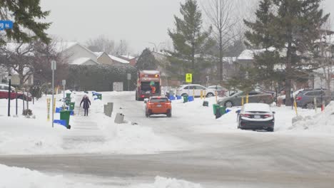 Garbage-truck-collecting-garbage-on-a-snowy-day