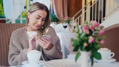 Woman-Uses-Smartphone-In-A-Restaurant