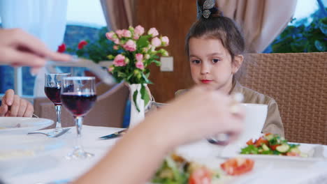 Young-Girl-Eating-in-Restaurant